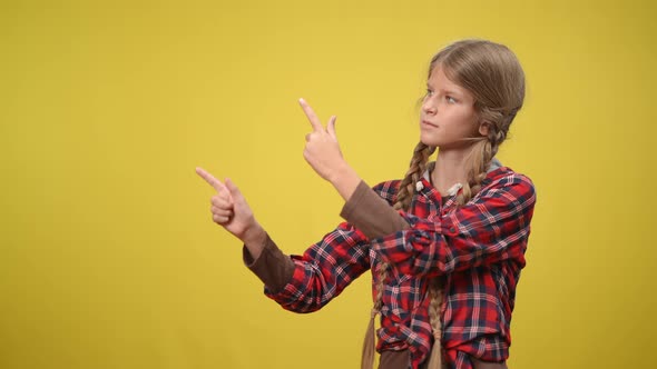 Teenage Girl with Pigtails and Grey Eyes Pointing Aside and Looking at Camera