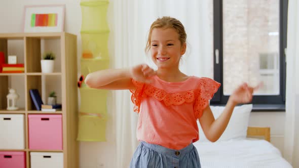 Happy Little Girl Dancing in Her Room at Home