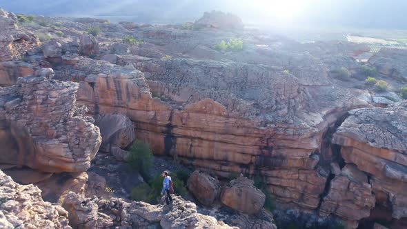 Male rock climber standing over a rocky mountain 4k