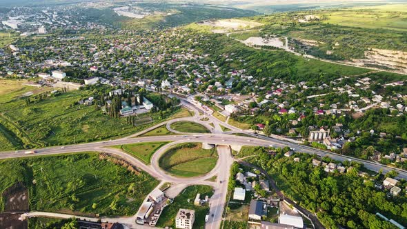 Aerial drone view of a village and road with cars, greenery, Moldova