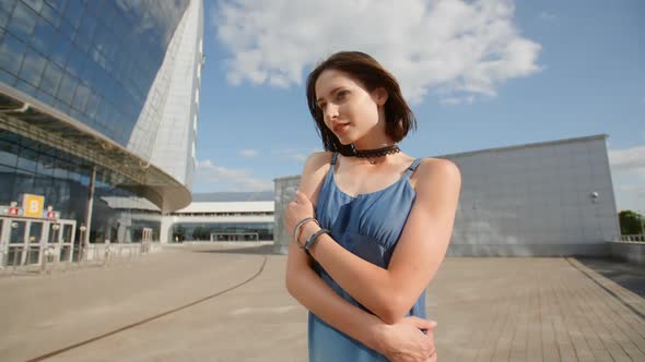 Sad Young Woman Posing With Industrial Background And Glass Buildings