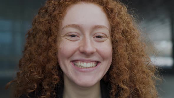 Closeup of red hair girl smiling in camera