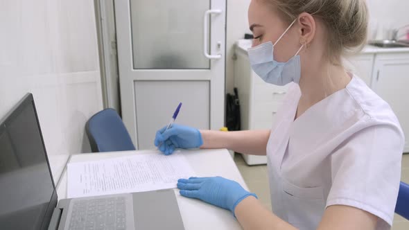 Dentist Assistant Writes Down Information About Patient on Examination