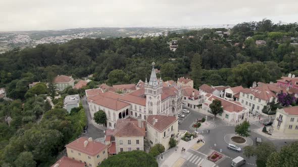 Colourful Sintra City Hall building surrounded by green and lush Natural Park forest, Portugal.