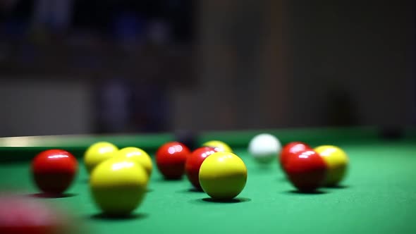 Balls on a green table during a billiards match