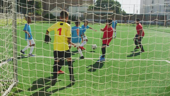 Soccer kids playing in a sunny day