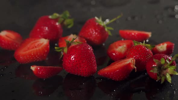 Strawberries on Black Background with Water Drops