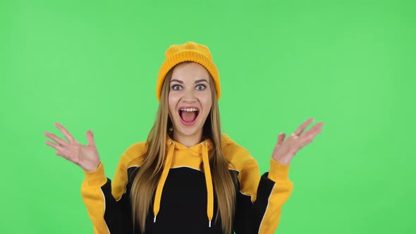 Portrait of Modern Girl in Yellow Hat with Shocked Surprised Wow Face Expression Is Rejoicing