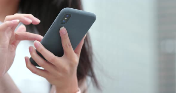 Woman using mobile phone in city