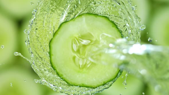 Super Slow Motion Shot of Splashing Water on Rotating Cucumber Slice at 1000Fps