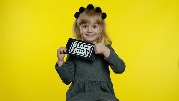 Child Girl Showing Black Friday Inscription, Smiling, Looking Satisfied with Low Prices, Discounts