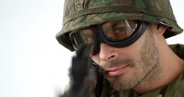 Soldier aiming rifle on white background