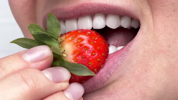 Perfect White Teeth Close Up Female Veneer Smile with Big Juicy Strawberry Dental Care and