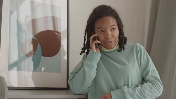 Cheerful Young Woman Making Telephone Call
