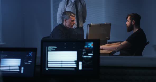 Technician Recording Interrogation of a Criminal