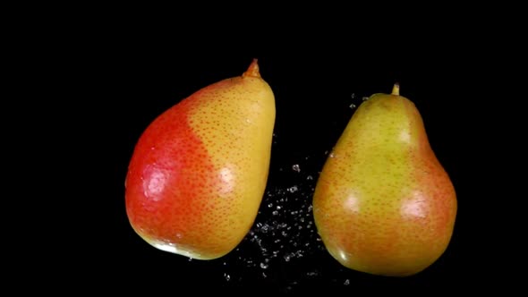 Two Juicy Pears Collide on a Black Background
