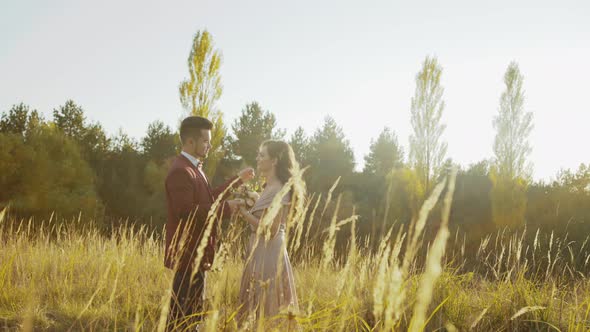 Wedding Couple in Love Looking and Kissing Each Other Among Summer Steppe