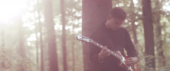 Guitar Player in the Woods