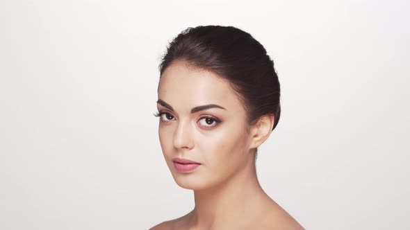 Studio portrait of young and beautiful brunette woman over