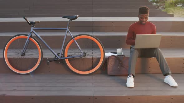 African American Businessman Working on Laptop Outdoors