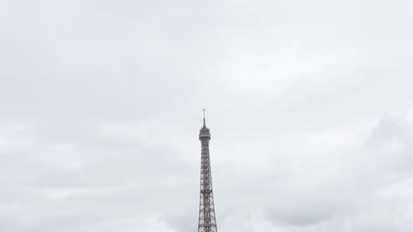 Famous French monument The Eiffel Tower in front of cloudy sky  slow tilt 4K 2160p 30fps UltraHD foo