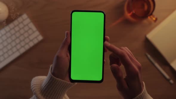 Woman Swiping Up of Green Screen Smartphone