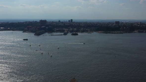 aerial high flown drone, pan right while viewing boats in the Hudson River looking towards New Jerse