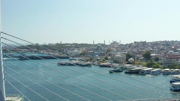 Scenic View of Bridge with Public Transportation Train Station in Istanbul, Aerial Forward Revealing