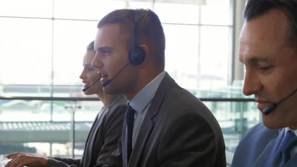 Business people wearing headsets in a modern office