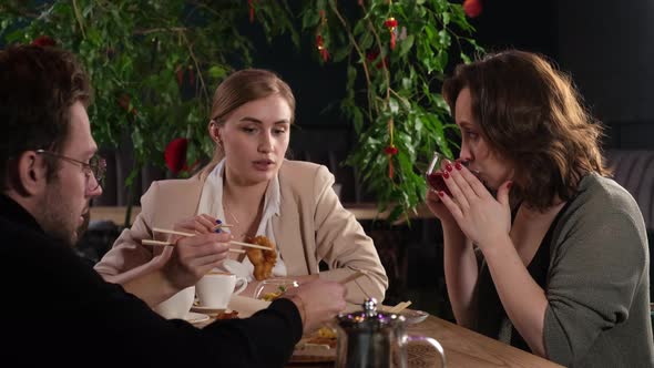 Two Girlfriends Talking in a Cafe at Lunch