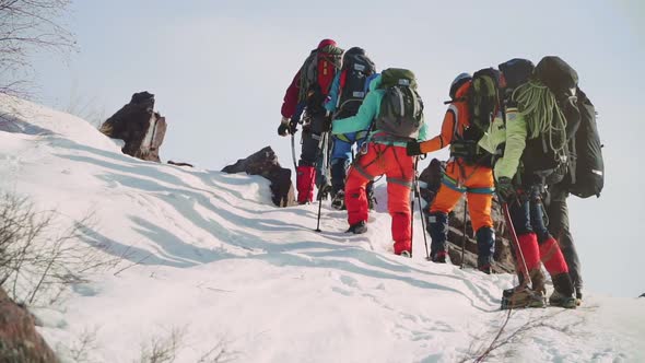 Slowly and Steadily a Solid Team of Climbers Ascends Along the Slope and Entered the Snow Winds