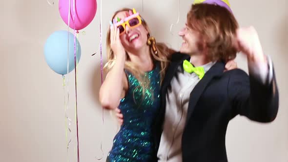 Couple dancing funny in photo booth