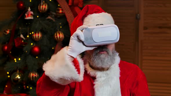 Portrait Santa Claus Wearing Virtual Reality Goggles with Wow Surprised Expression on His Face