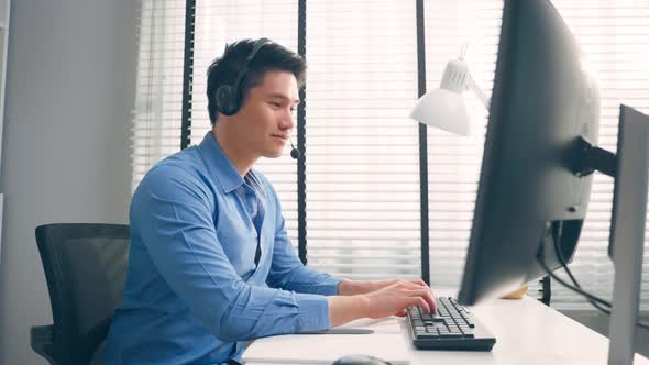 Asian handsome business man using laptop computer working in office workplace.