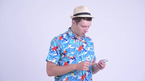 Stressed Young Tourist Man Using Phone and Getting Bad News