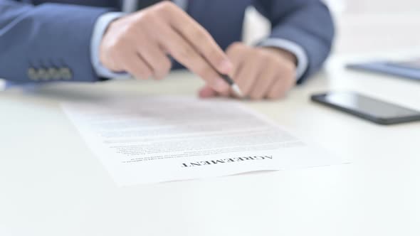 Businessman Reading Agreement