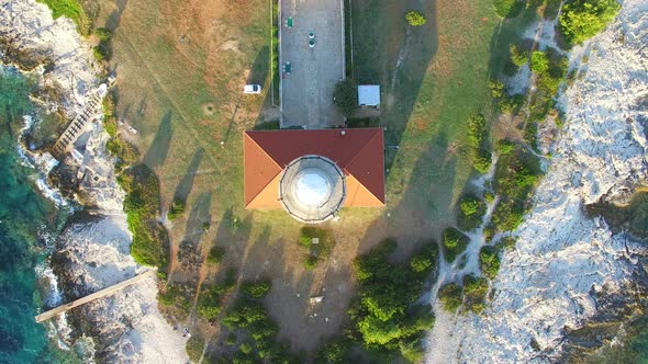 Flying over lighthouse, Croatia with a red tiled roof