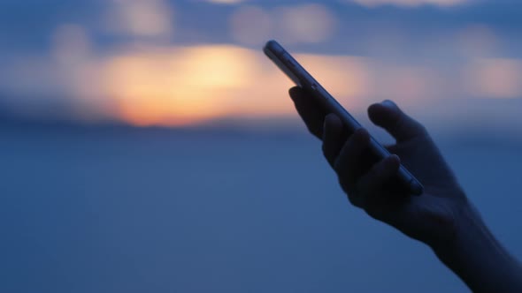 Using Smartphone At Sunset