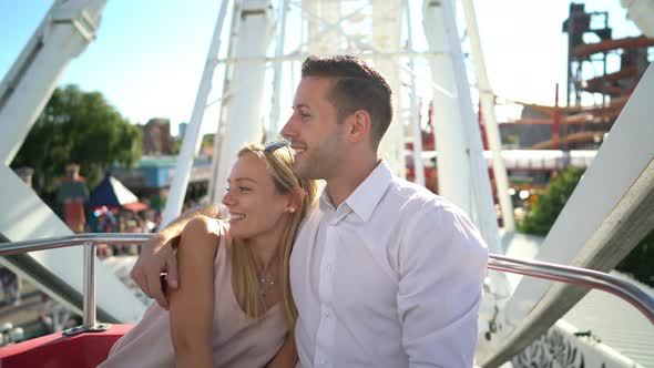 Couple in Big Wheel of Amusement Park