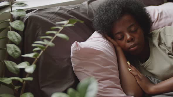 Afro-American Woman Sleeping in Bed at Home