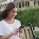 Young Woman Using Smartphone On Bench In City - VideoHive Item for Sale