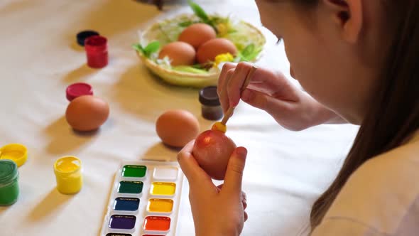 Child Girl Having Fun During Painting Eggs for Easter in Spring Time at Home