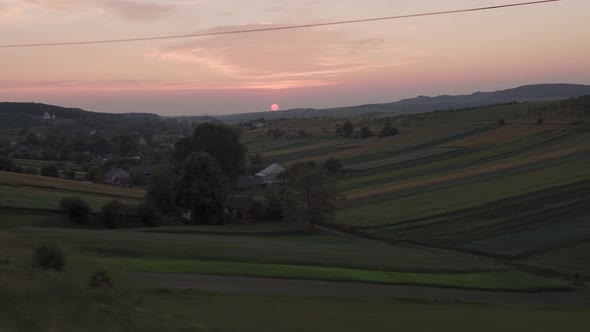 View From Window Highspeed Train on Landscape of Nature Field and Forest on Evening Dusk Sky Sunset