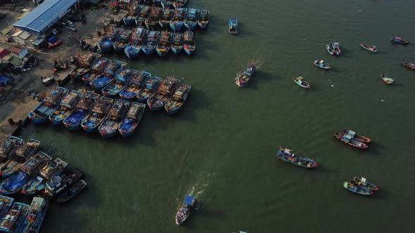 Huge Vietnamese fishing industry in local harbor, aerial view. Boats sailing