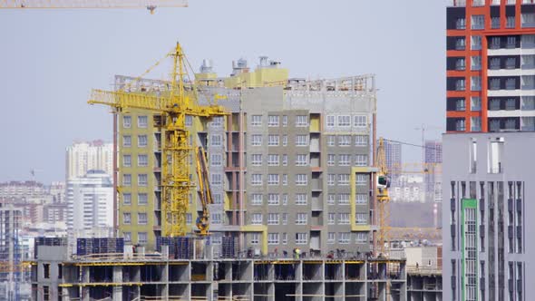 Construction of the House with a Crane and People