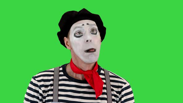 Mime Artist Holding Imaginary Balloons and Flying on a Green Screen Chroma Key