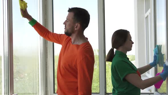 Workers of a professional cleaning company wash windows.