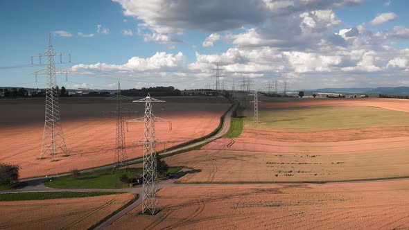 High voltage steel power pylons in field at countryside