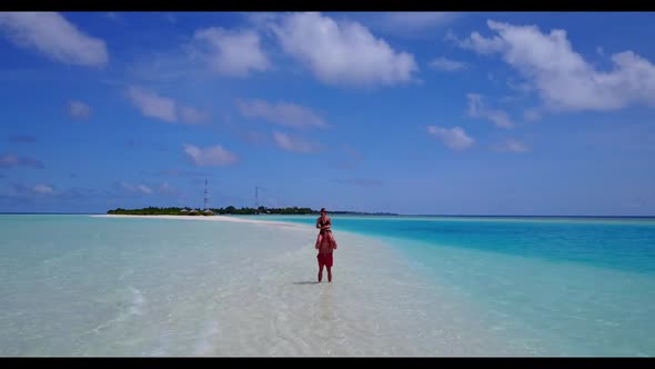 Guy and girl in love on idyllic island beach voyage by blue green sea and white sandy background of 