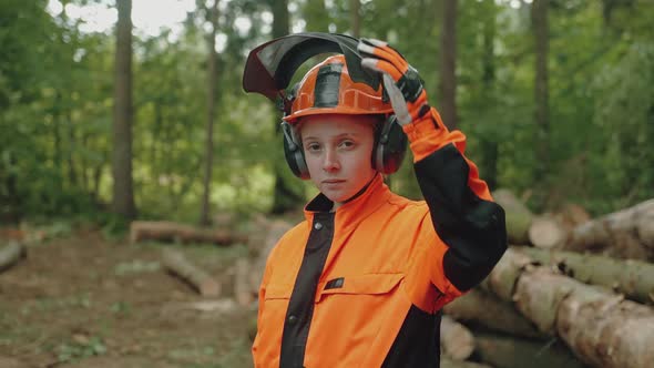Portrait of a Female Logger Standing in the Forest a Young Specialist Woman in Protective Gear